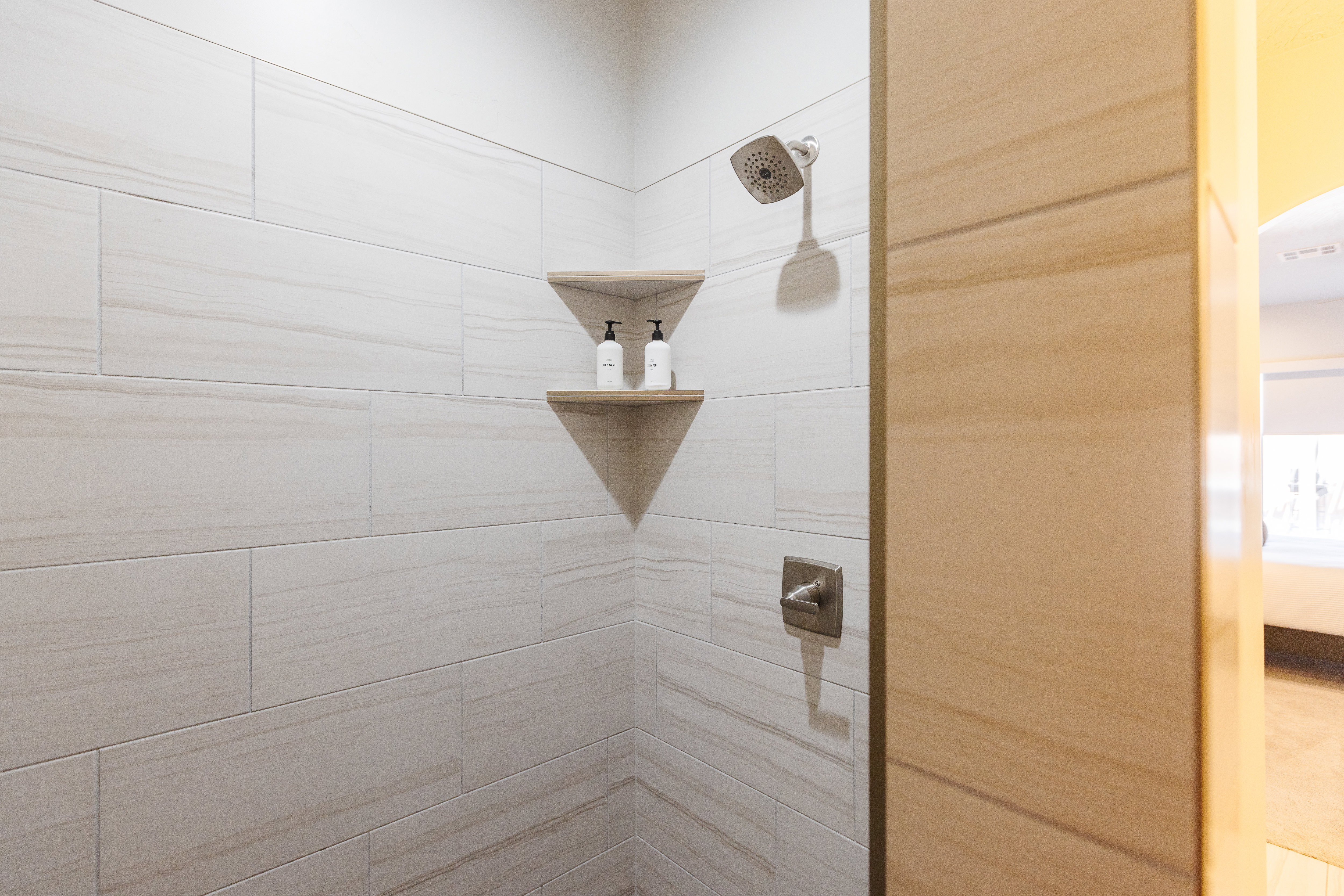 Full bathroom featuring a tile shower and ensuite bathroom
