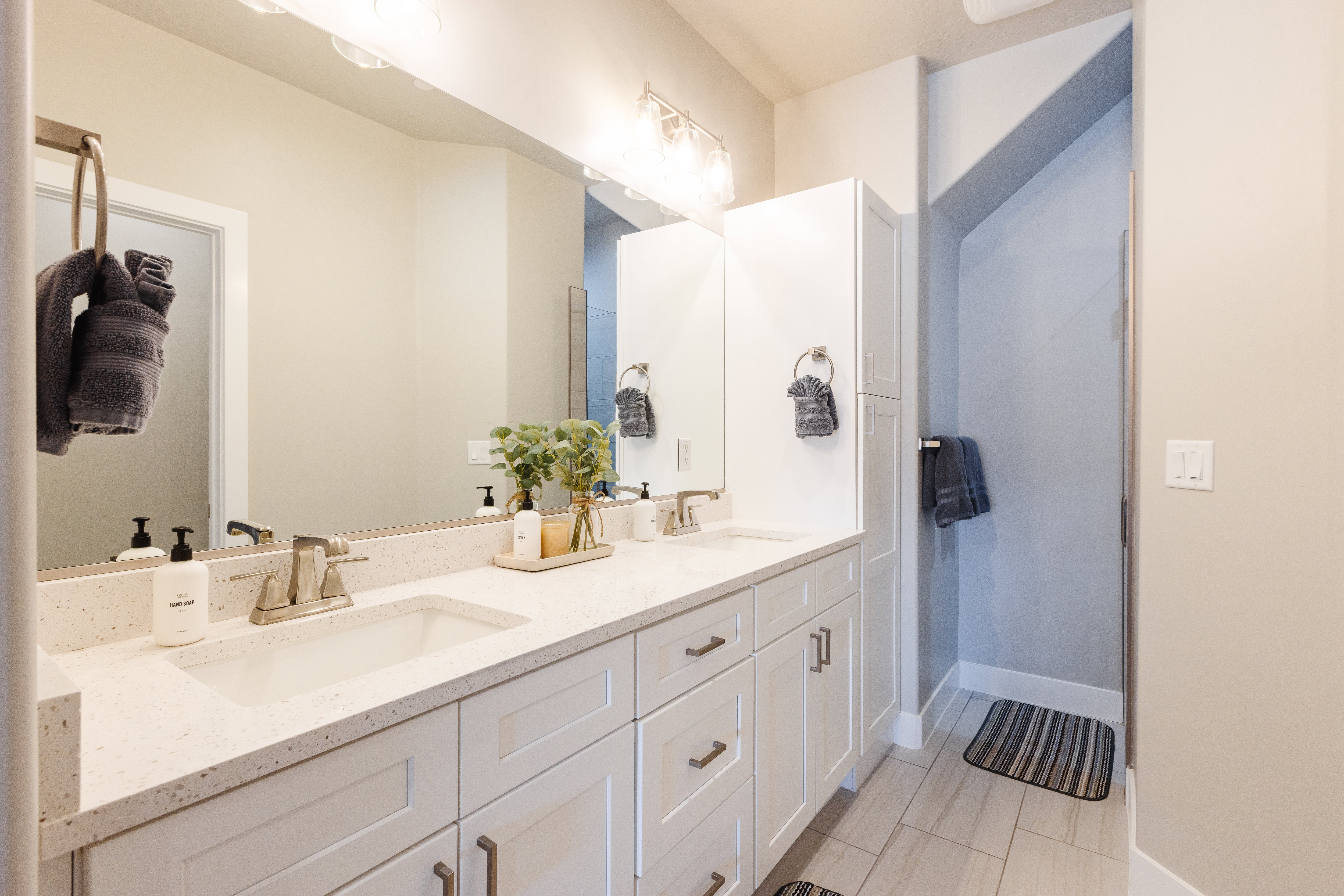 Bathroom featuring double vanity and baseboards