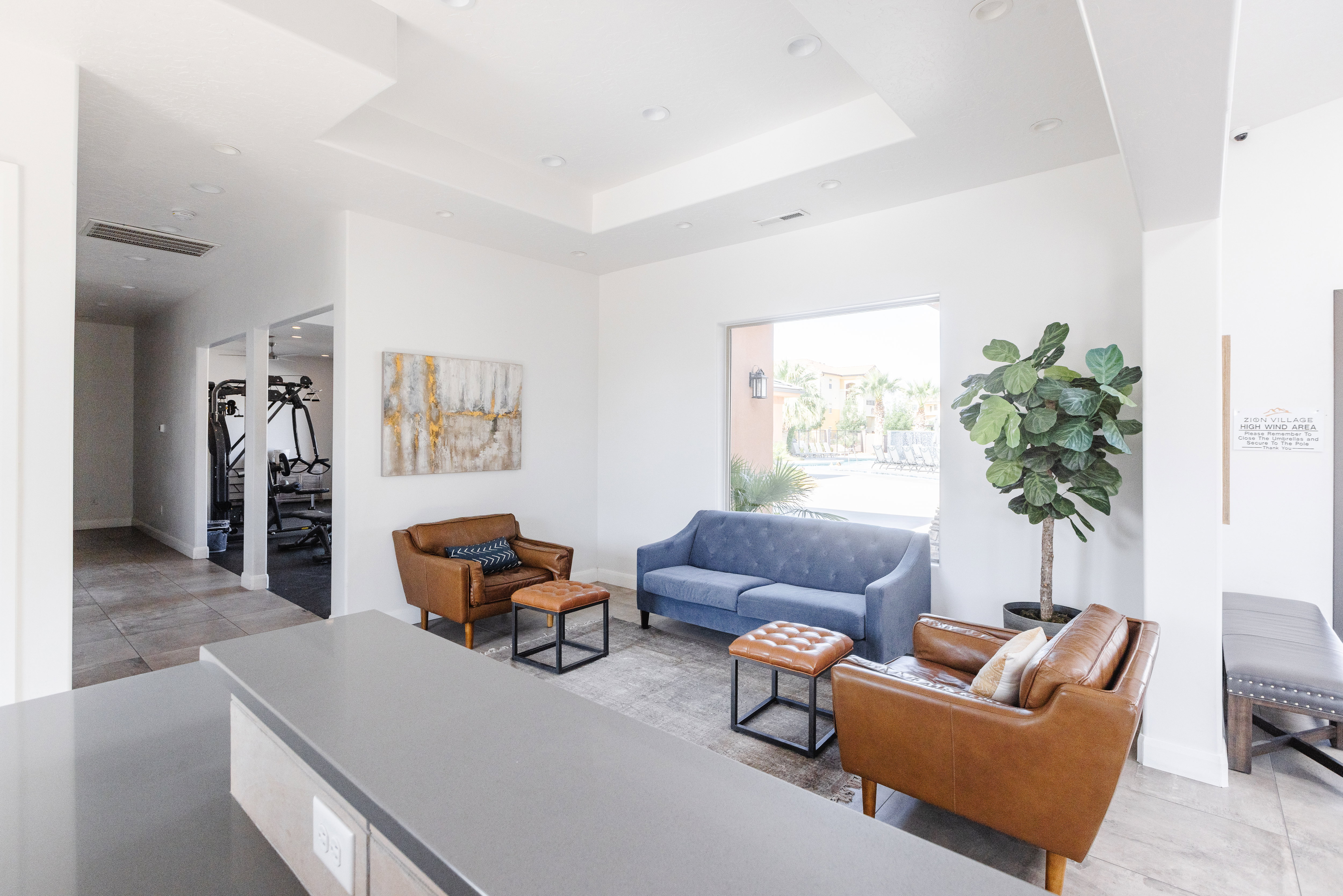 Living area with a tray ceiling and light tile patterned floors