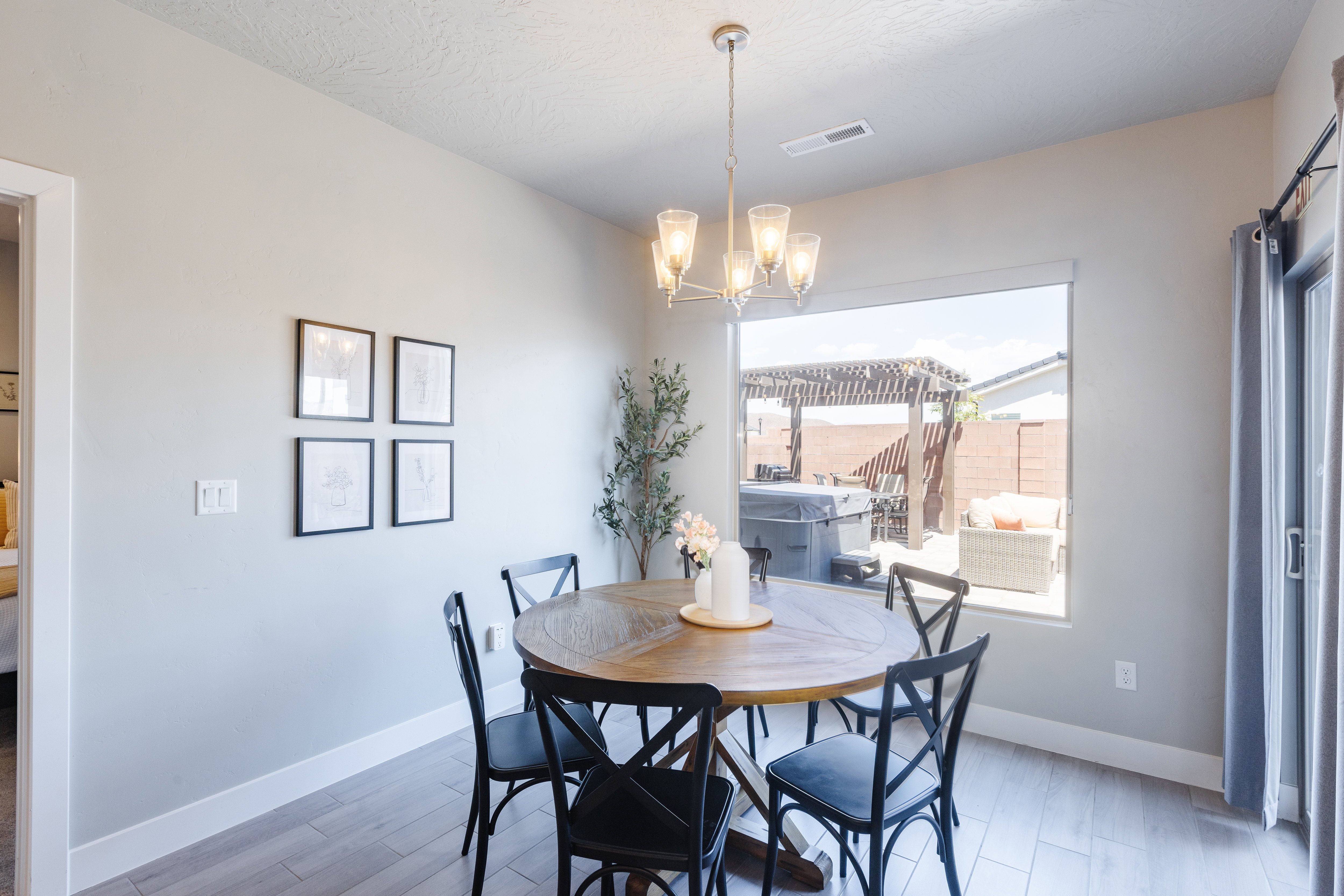 Dining space with light wood-type flooring and suspended lighting