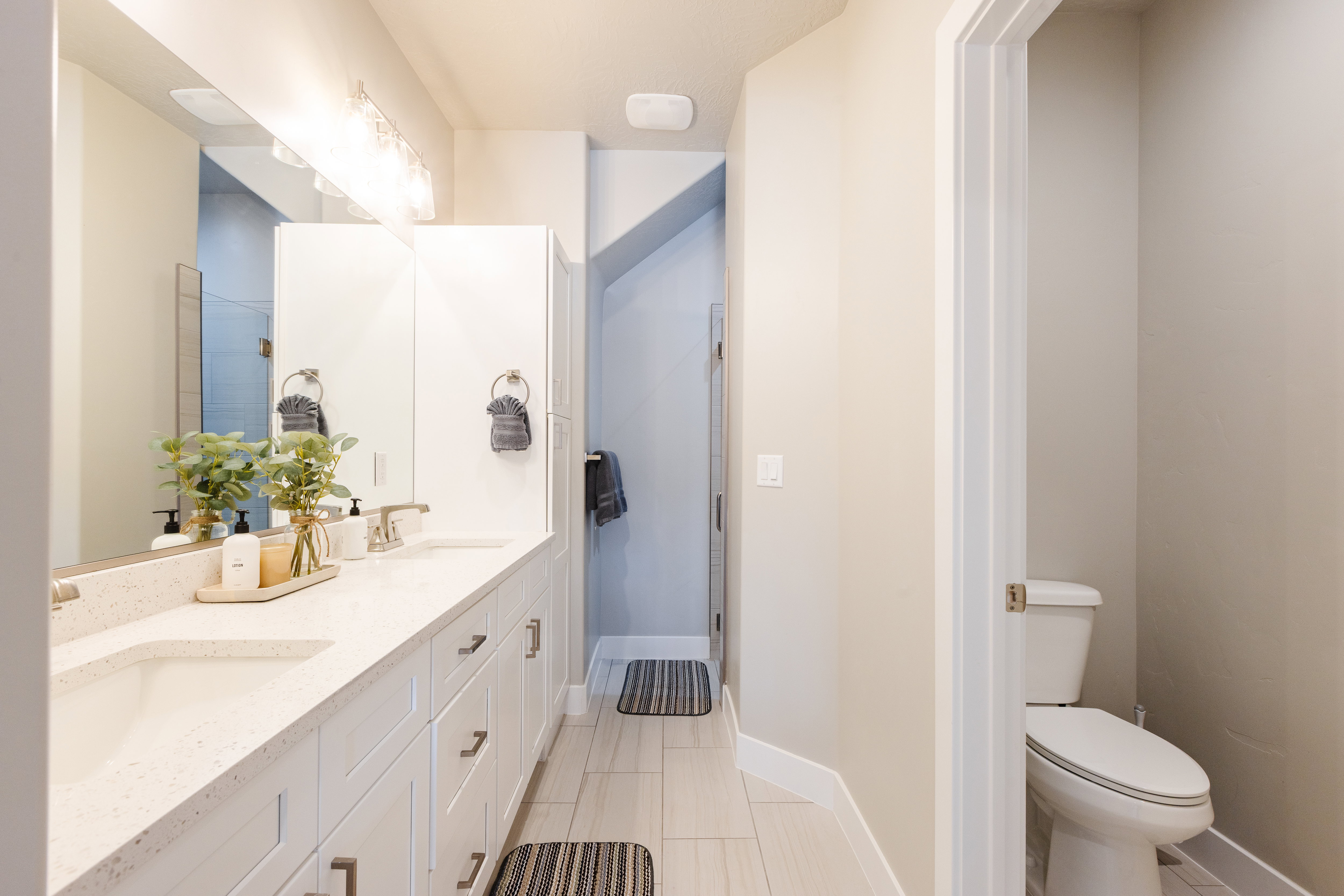 Bathroom with double vanity and a stall shower
