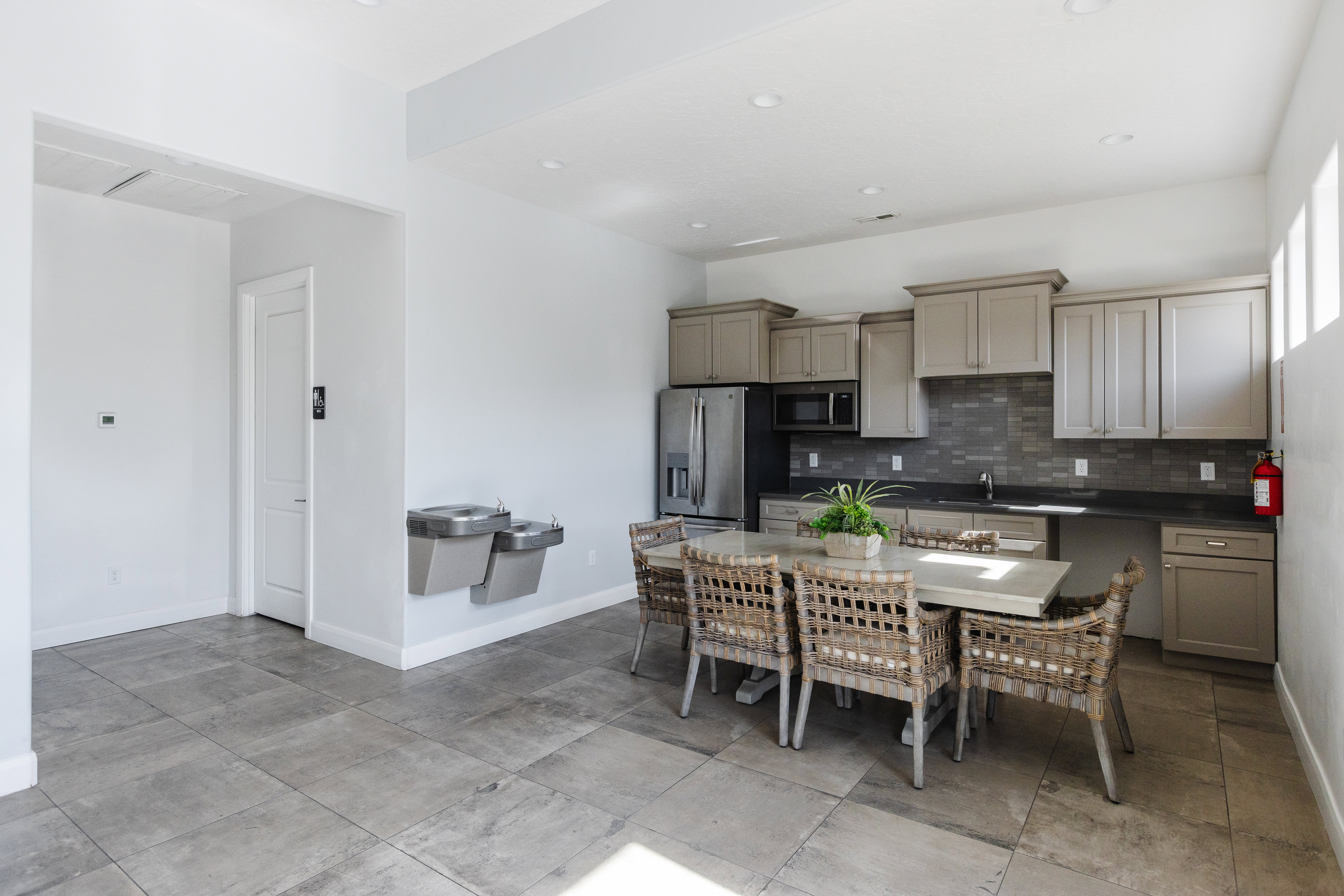 Kitchen featuring stainless steel appliances, dark countertops, and backsplash