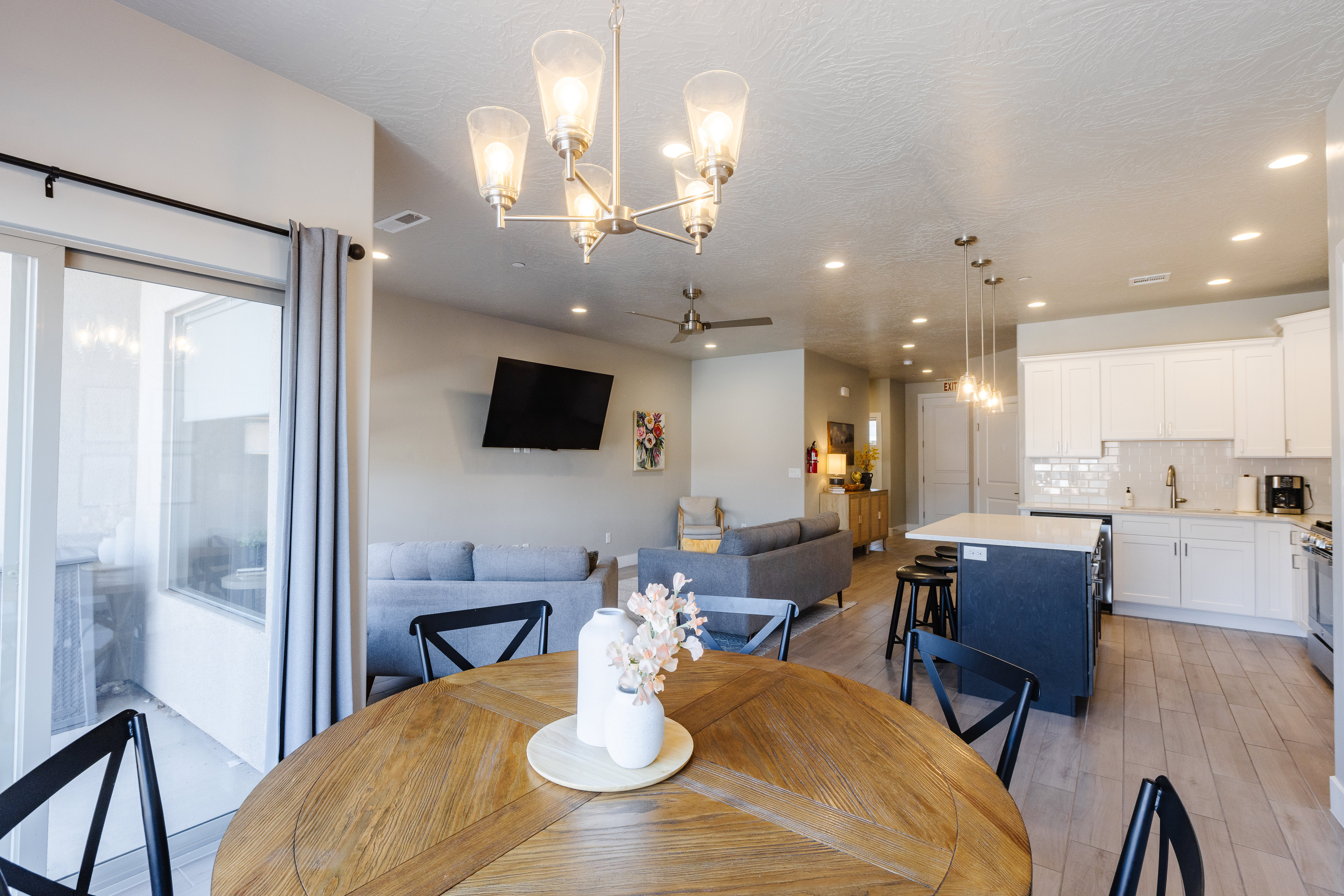 Dining area featuring hanging lights, ceiling fan, and light wood-style flooring