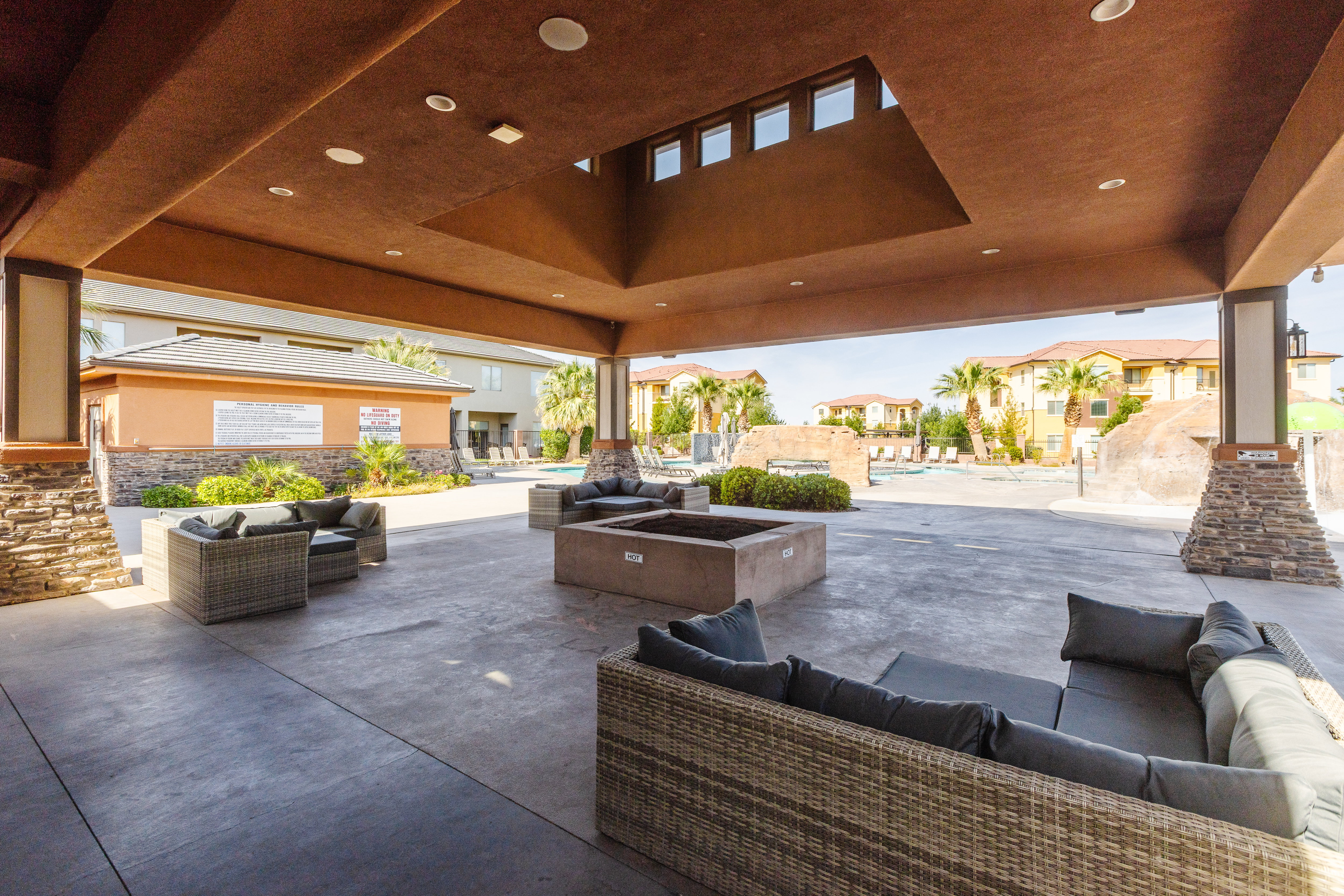 View of patio / terrace featuring an outdoor living space with a fire pit, a community pool, and a residential view