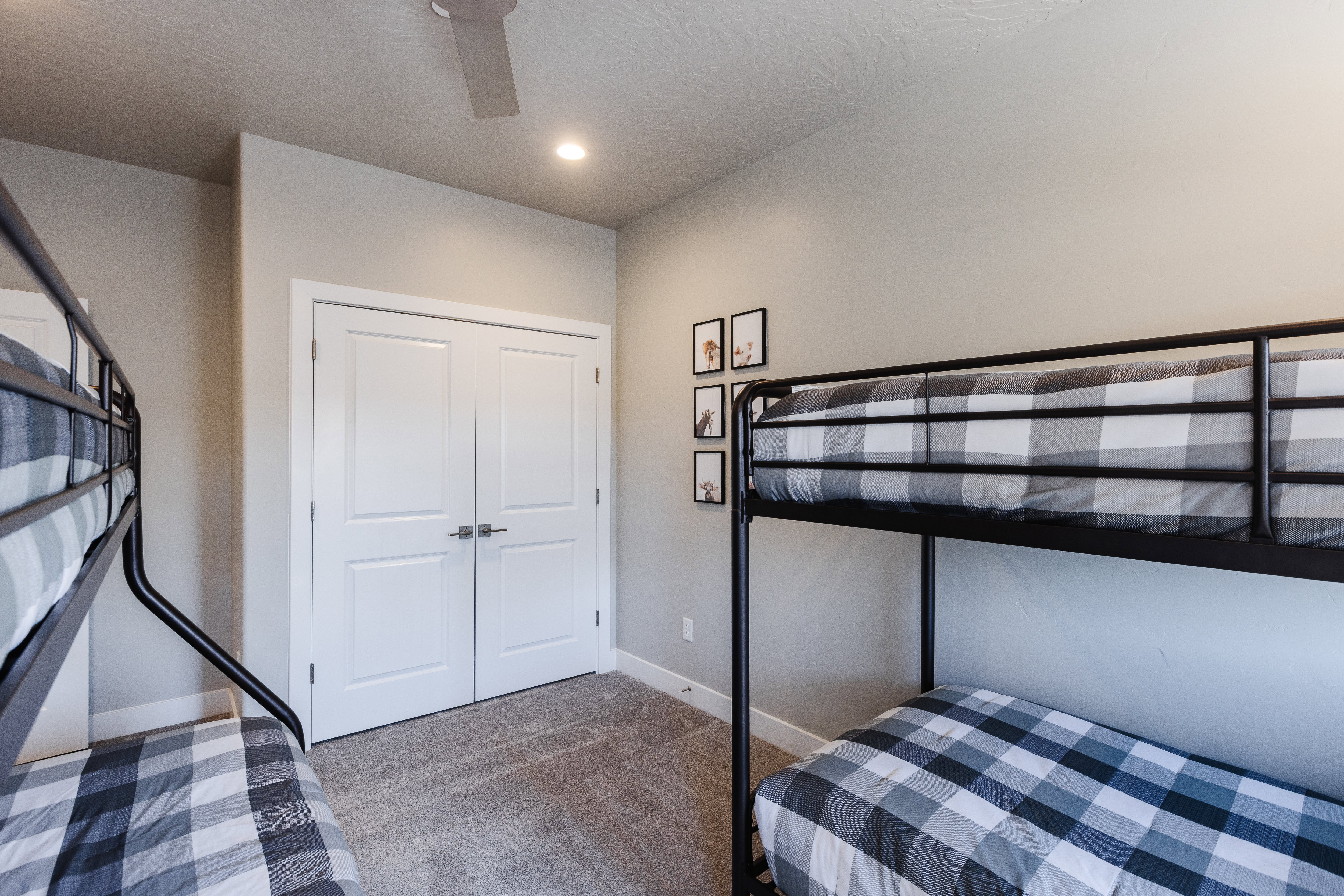 Carpeted bedroom featuring a ceiling fan and a closet