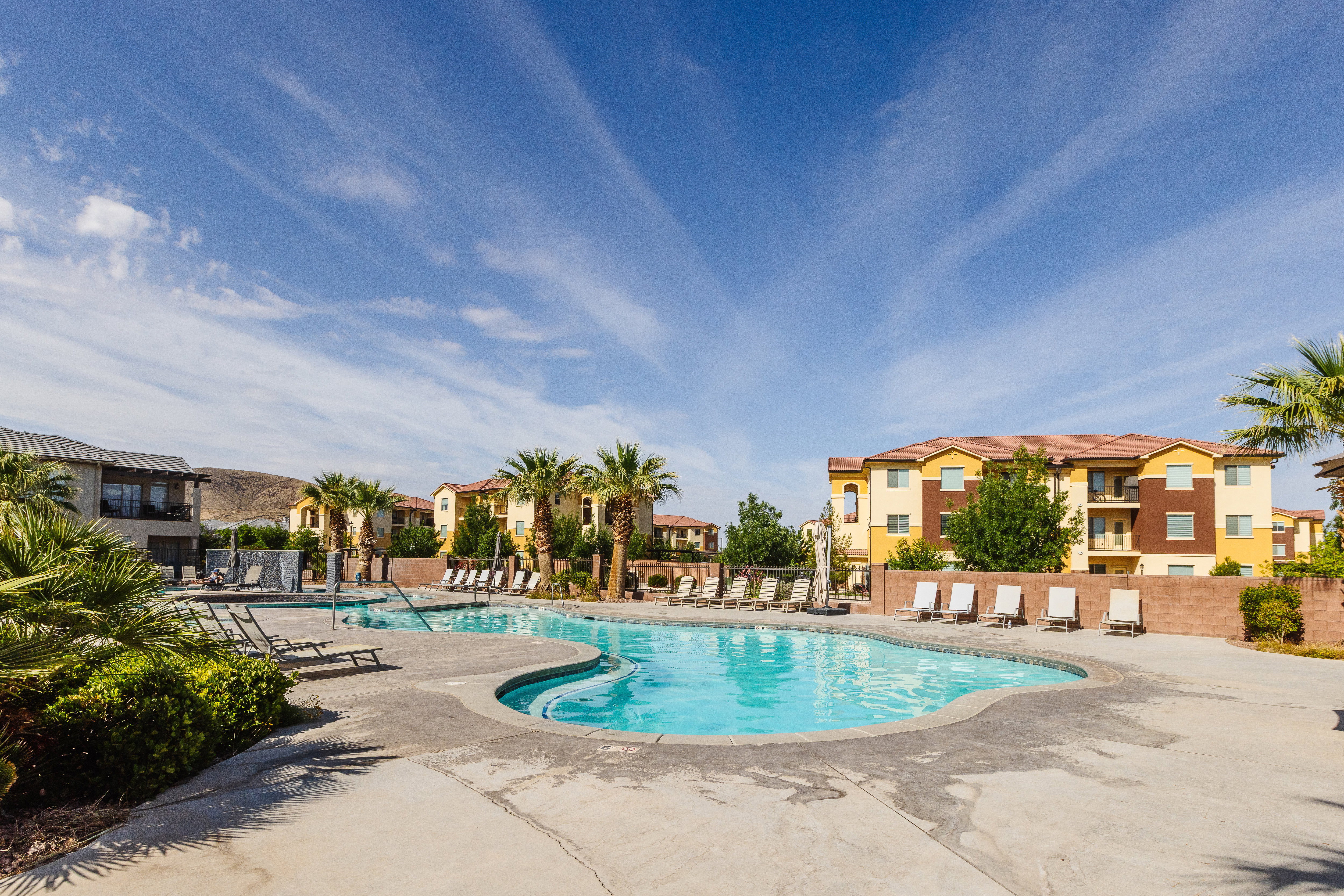 Community pool with a patio and a residential view