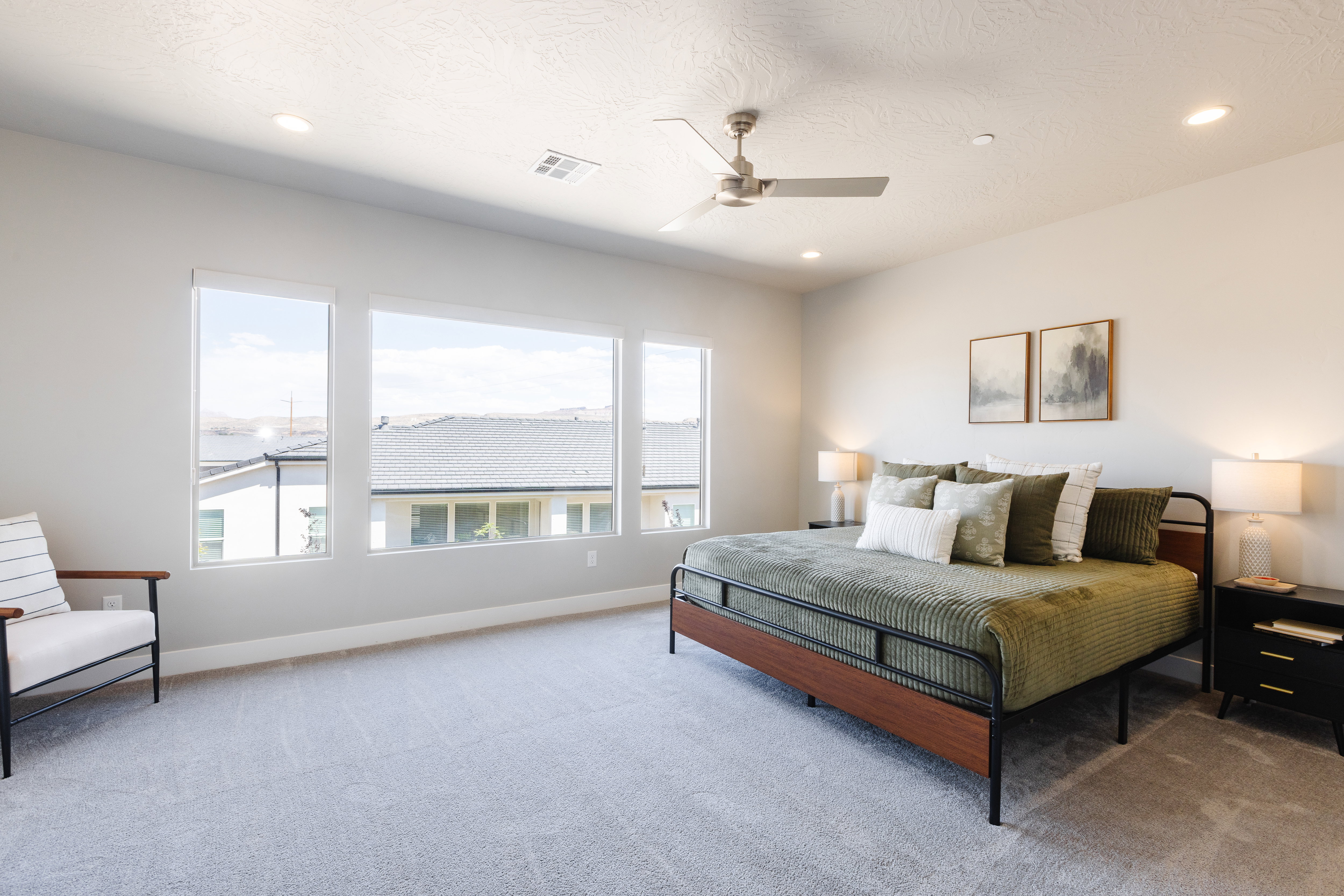 Bedroom with light carpet, a ceiling fan, and recessed lighting