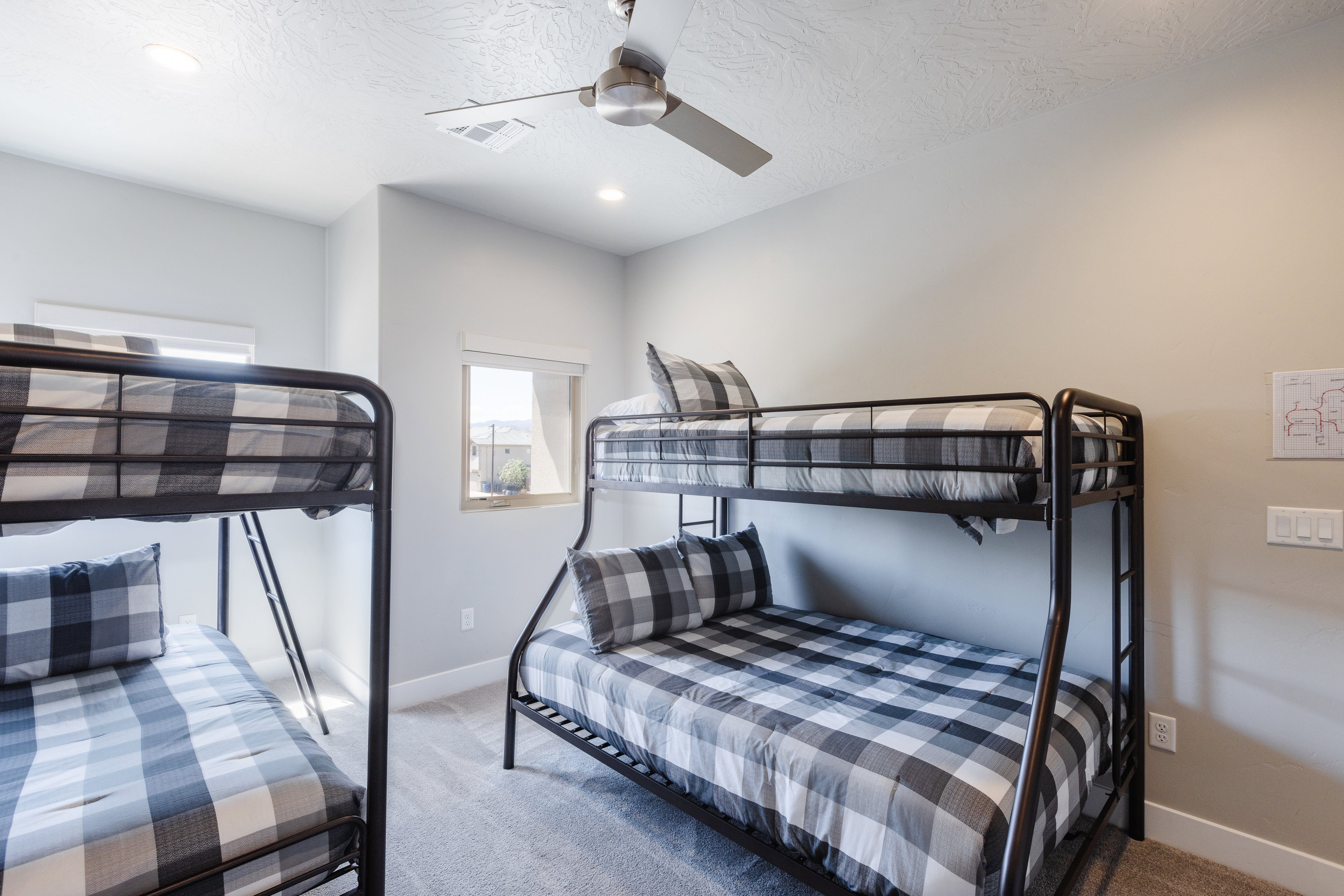 Carpeted bedroom with baseboards and a ceiling fan