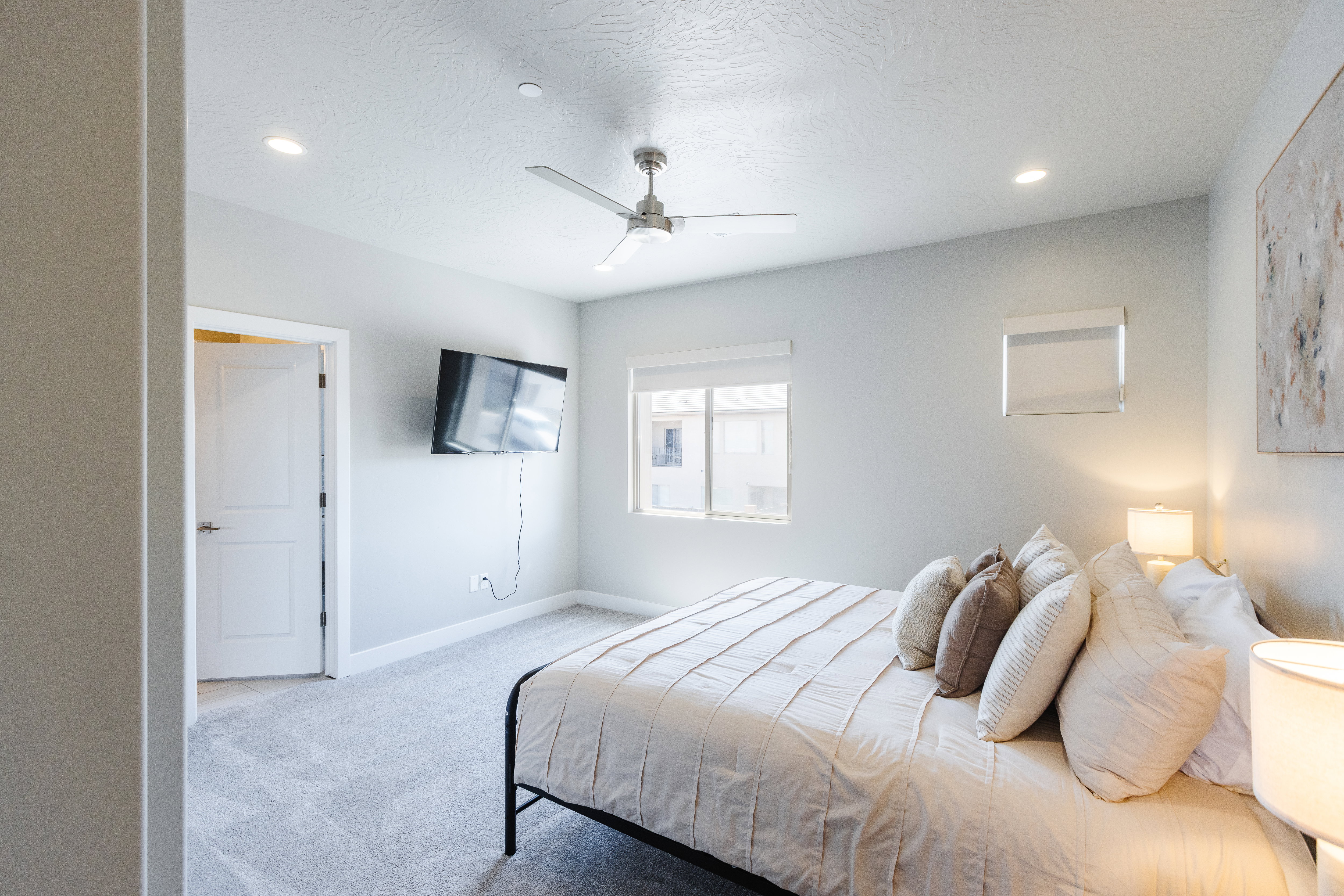 Bedroom featuring light carpet, ceiling fan, recessed lighting, and a textured ceiling