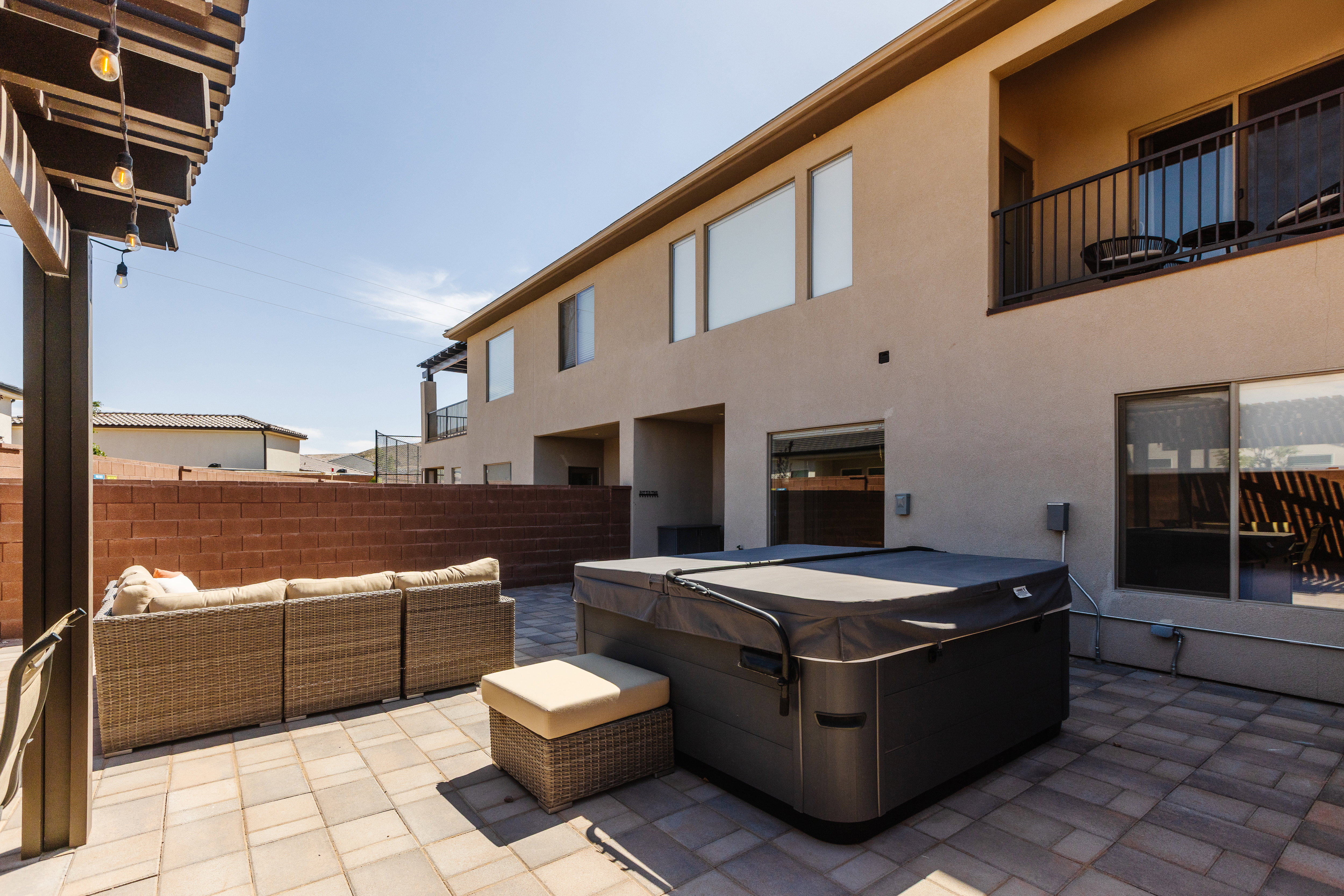 View of patio featuring a hot tub and an outdoor hangout area