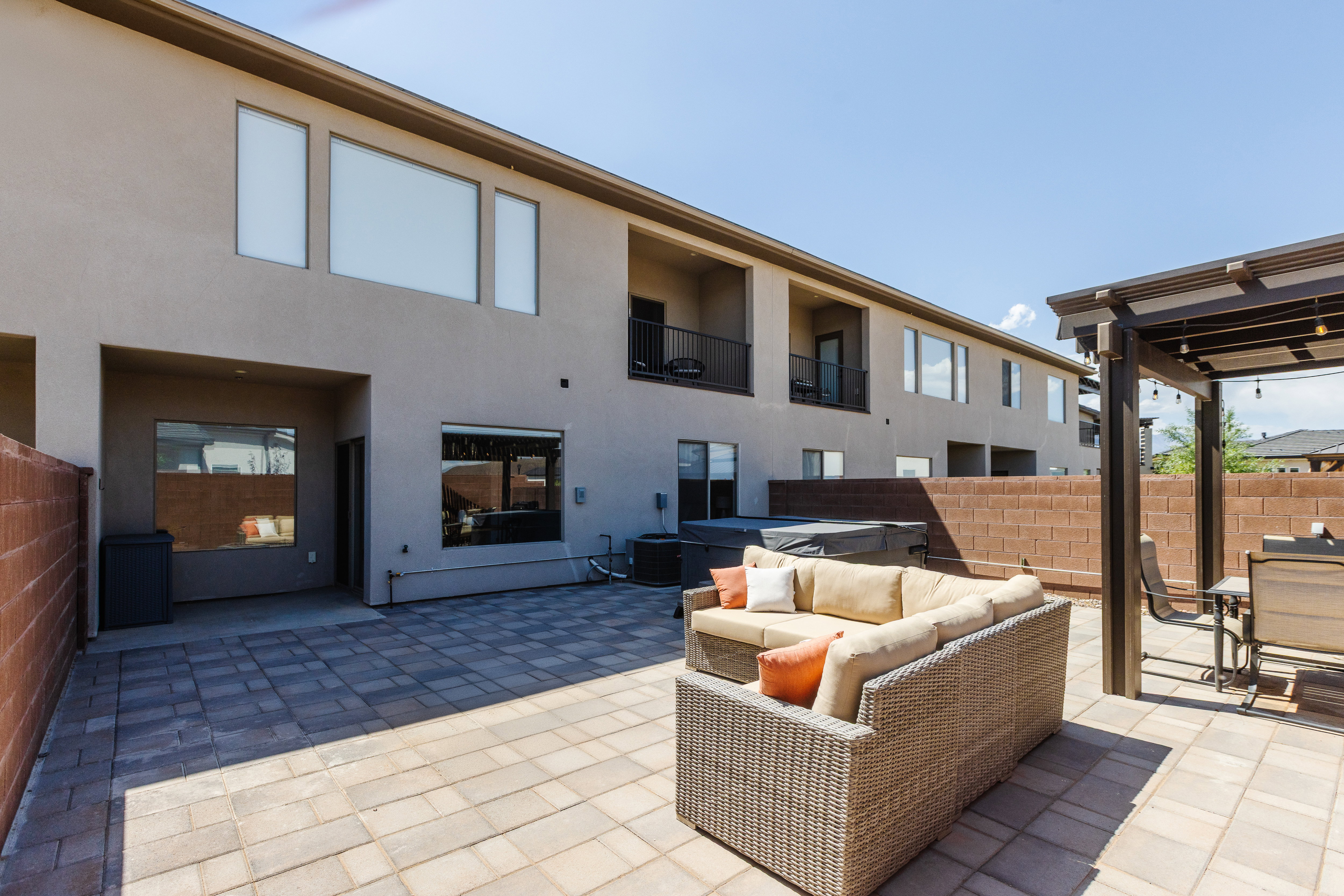 View of patio featuring a hot tub and an outdoor lounge area