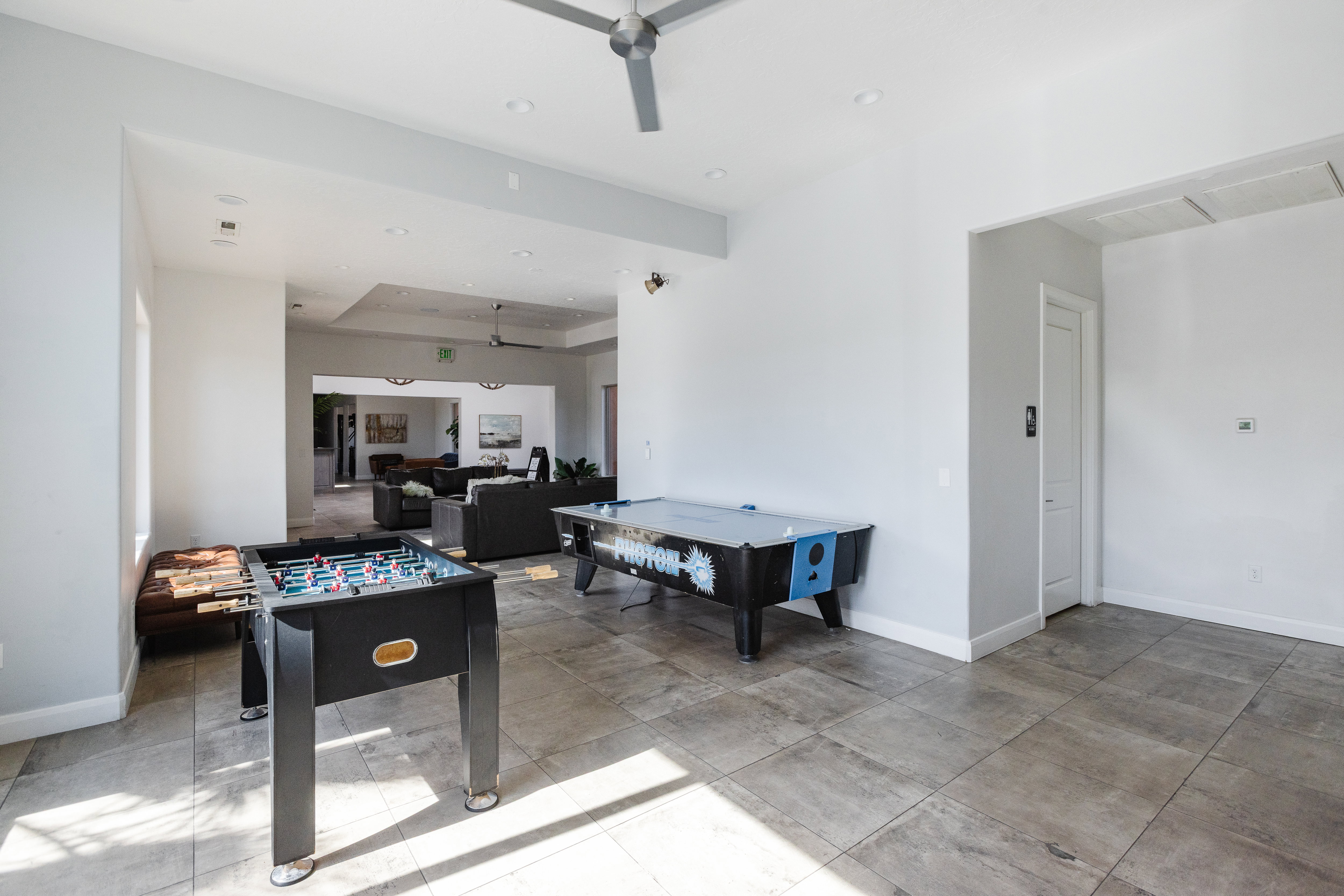 Rec room featuring a ceiling fan, recessed lighting, and a raised ceiling