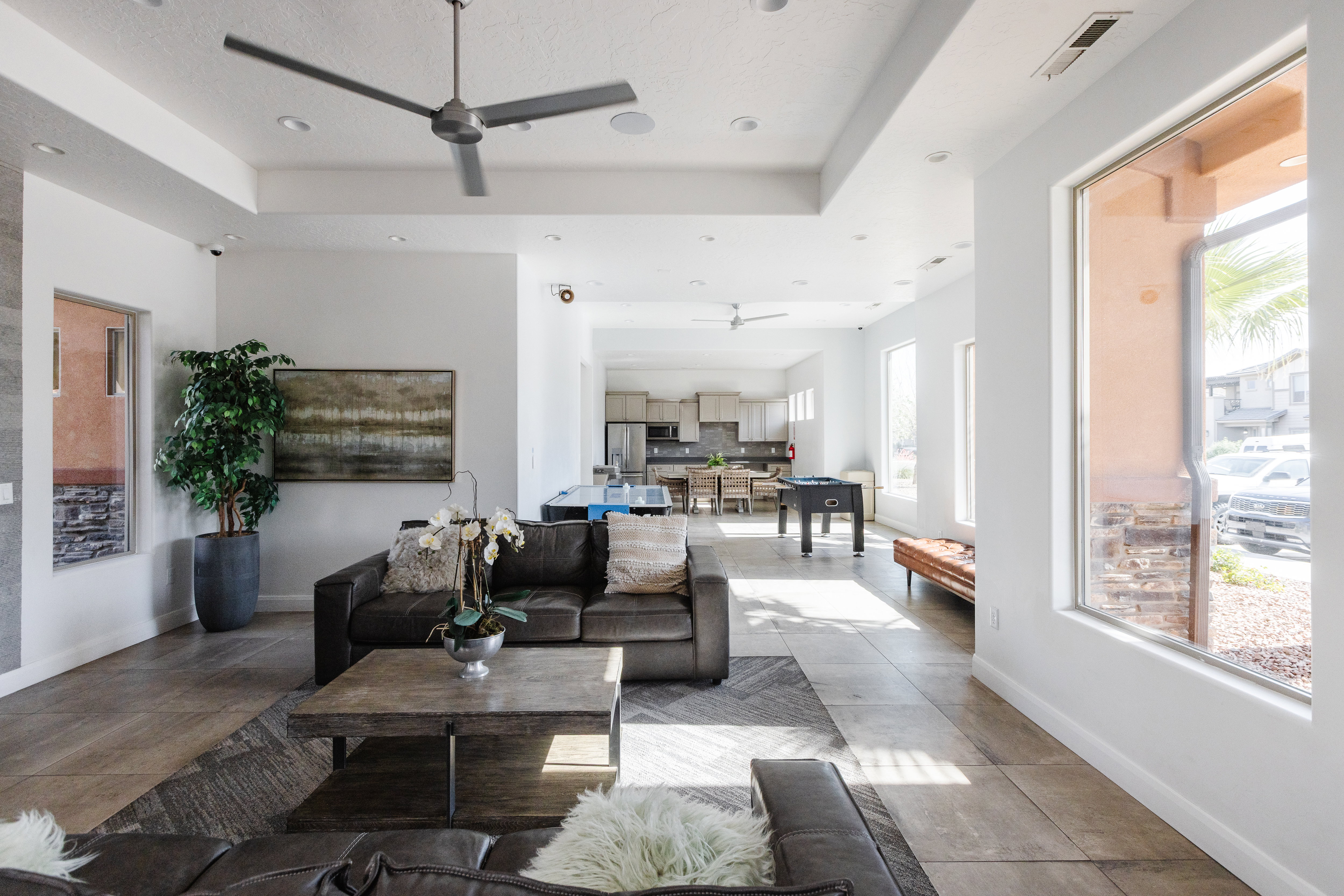 Living area featuring a ceiling fan and a tray ceiling
