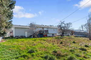 Back of property with a chimney and a wooden deck