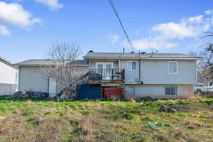 Rear view of house featuring french doors and a deck