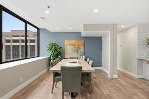Dining space with light wood-style flooring and recessed lighting