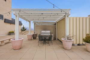 View of patio featuring outdoor dining area and a pergola