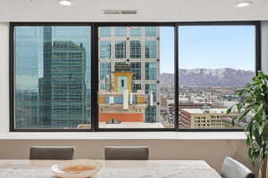 Dining room with recessed lighting, a city view, and a mountain view