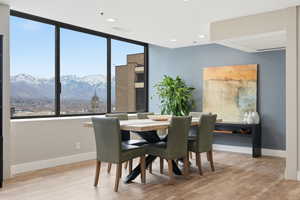 Dining space featuring light wood finished floors, a mountain view, and recessed lighting