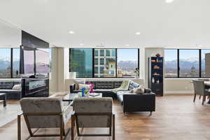 Living area featuring a mountain view, light wood-style flooring, and recessed lighting