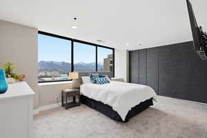 Bedroom with light carpet, a mountain view, and recessed lighting
