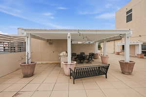 View of patio featuring a pergola and outdoor dining area
