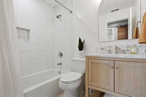 Bathroom with shower / bath combo with shower curtain and vanity