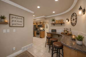 AI version of basement kitchen. Curved bar featuring a speckled countertop, tile backsplash, wood-finish cabinetry, and recessed lighting