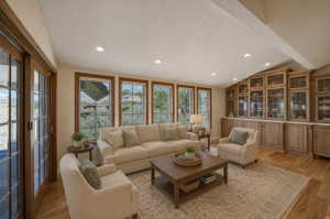 AI version of sunroom off kitchen Bright living space featuring wood-finish flooring and recessed lighting
