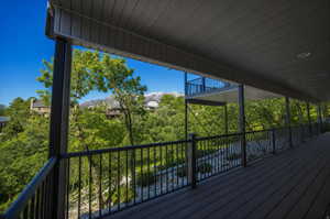 Expansive covered deck featuring composite decking and a black metal railing system