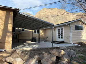 Rear view of property featuring french doors and a patio area