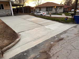 Exterior space featuring a carport and driveway