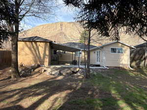 Rear view of property featuring a patio and a mountain view