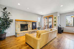 Living area featuring light wood-type flooring, a fireplace, and recessed lighting