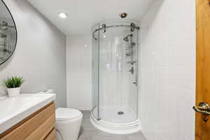 Full bathroom featuring vanity and a shower stall