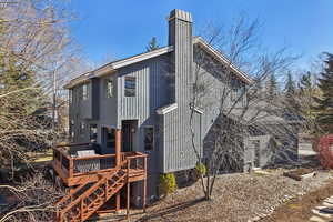 Back of property featuring a deck and a chimney