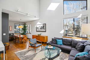 Living area featuring hardwood / wood-style floors and a high ceiling
