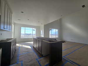 Kitchen featuring wood finished floors, a kitchen island, and a textured ceiling