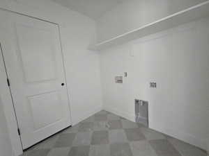 Laundry area with dark flooring and hookup for a washing machine