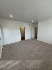 Unfurnished bedroom featuring carpet and recessed lighting