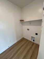 Laundry room featuring dark wood-type flooring and washer hookup