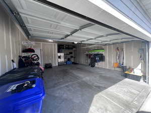 Garage with stainless steel refrigerator with ice dispenser