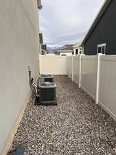 Fenced backyard with a mountain view featuring two a/c units