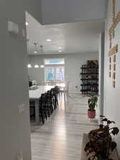 Dining space with light wood-type flooring, a textured ceiling, and recessed lighting