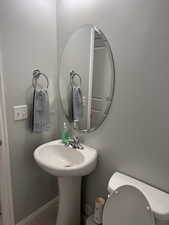 Bathroom with toilet and baseboards