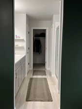 Ensuite Bathroom featuring vanity, a textured ceiling, a walk in closet, and a stall shower