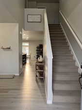 Stairs to 2nd level with recessed lighting, and high ceiling