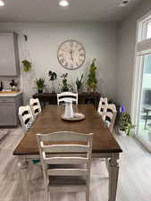 Dining room featuring light wood finished floors and recessed lighting