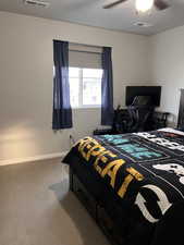 Carpeted bedroom with baseboards and a ceiling fan