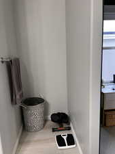 Master Bathroom nook with detailed view of baseboards and wood finished floors